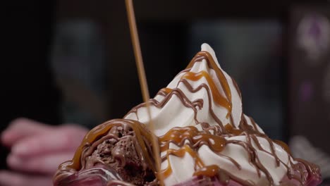 Pouring-caramel-over-ice-cream-dessert