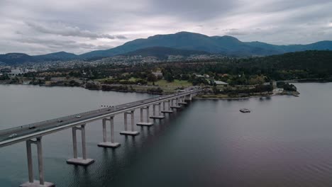Forward-drone-shot-of-a-bridge-connecting-two-cities-in-Hobart,-Australia