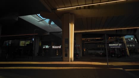 Dark-Amsterdam-Noord-metro-station-entrance-at-modern-concrete-overpass