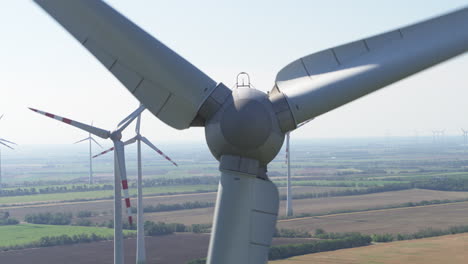 Abstract-close-up-aerial-of-a-wind-turbine-with-other-turvbines-in-the-background