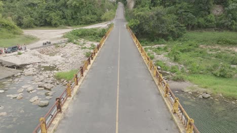 Aerial-forward-over-bridge-of-old-road-connecting-La-Romana-to-Higuey,-Chavon-river-in-Dominican-Republic