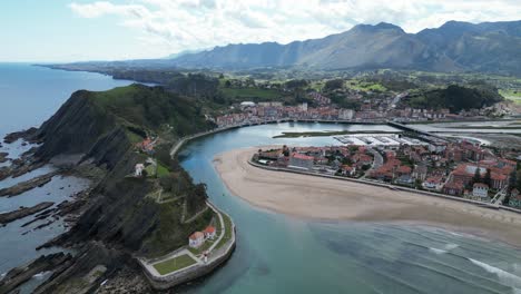 Ribadesella-Cliffs-and-Coastal-Town-in-Asturias,-North-Spain---Aerial-4k