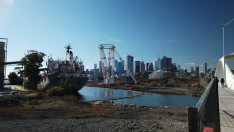 Wide-establishing-shot-of-Toronto-Port-Lands,-docked-ship-and-city-skyline-in-the-distance