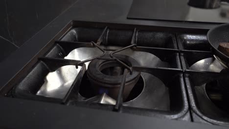 Turning-On-Gas-Stove-And-Putting-Pan-In-The-Kitchen
