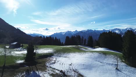 Drone-fly-above-beautiful-winter-mountain-landscape-with-snowcapped-mountains-on-a-sunny-day-sky-in-Austria