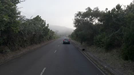 One-car-driving-on-asphalt-road-,-La-Fajana,-North-Coast,-La-Palma,-Spain