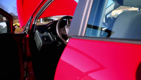 A-Red-Vehicle-with-Deployed-Airbags-on-the-Steering-Wheel-After-a-Collision---Close-Up