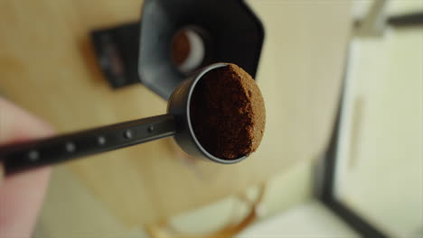 Coffee-powder-is-poured-into-a-coffee-press-view-from-a-unique-angle