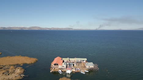 Aerial-view-of-Uros-Floating-Islands-on-Lake-Titicaca,-the-highest-navigable-lake-in-the-world,-on-the-border-of-Peru-and-Bolivia,-South-America