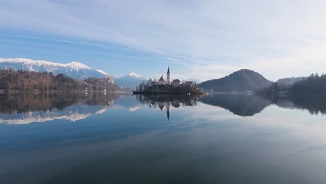 Static-shot-of-calm-Bled-lake-with-mountains-at-background