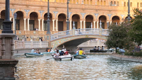 Tourists-rowing-boats-on-artificial-canal-in-Plaza-de-España,-Seville,-Spain