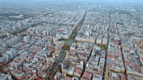 Alameda-street-cityscape-with-bicentenary-flag-and-presidential-palace-la-moneda,-aerial-view