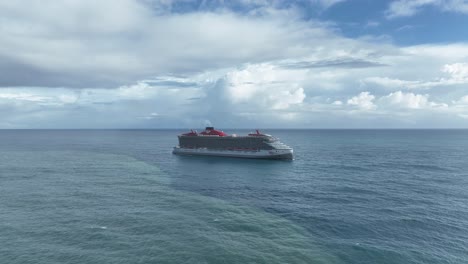 Virgin-big-cruise-ship-navigating-in-open-ocean-arriving-at-port-of-Puerto-Plata-in-Dominican-Republic