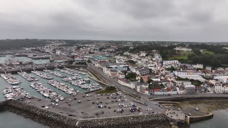 St,-Peter-Port,-Guernsey,-Channel-Islands,-Drone-Shot-of-Harbor,-Marina-and-Waterfront-Buildings