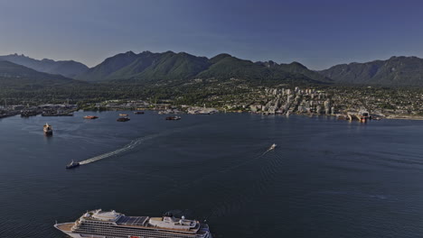 Vancouver-BC-Canada-Aerial-v38-drone-flyover-the-harbour-capturing-cruise-ship-sailing-on-the-water-against-views-of-North-shore-mountain-and-industrial-area---Shot-with-Mavic-3-Pro-Cine---July-2023