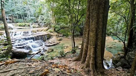 Tranquil-forest-waterfall-at-Erawan-National-Park,-Kanchanaburi-with-cascades-among-green-trees