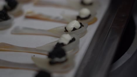 Preparing-Cream-Cheese-Caviars-On-Spoons.-closeup-shot