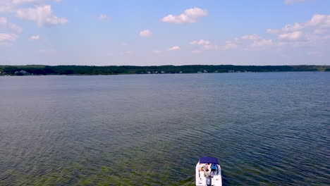 Drone-following-small-fishing-boat-in-local-bay-off-of-the-ocean