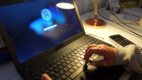 Girl-typing-the-password-on-the-laptop-at-night-time
