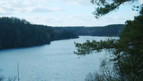 The-View-from-the-Observation-Deck-at-the-Top-of-a-Hill-at-a-National-Park-Overlooking-a-Huge-Lake-Surrounded-by-Woods
