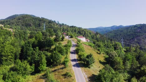 Siga-Una-Toma-De-Drones-De-Un-Camino-Sinuoso-Que-Se-Mueve-A-Lo-Largo-De-Las-Crestas-De-La-Cordillera-De-Ródope-Que-Conduce-A-La-Ubicación-De-La-Roca-Del-Águila-En-Bulgaria