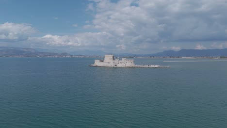 Flying-over-sea-fortress-Bourtsi-in-Nauplio,-Greece-|-4k-60fps