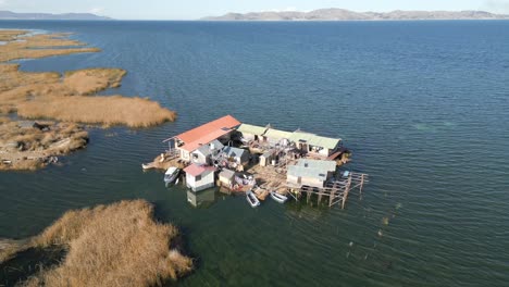 Aerial-view-of-Uros-Floating-Islands-on-Lake-Titicaca,-the-highest-navigable-lake-in-the-world,-on-the-border-of-Peru,-South-America
