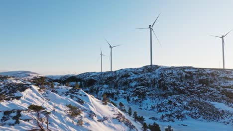 Winter-Landscape-With-Wind-Turbines-In-Mountains-Of-Bessaker,-Norway---Drone-Pullback