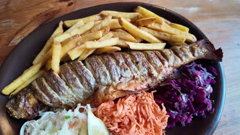Baked-Trout-Served-With-Mixed-Salads,-Fries-And-Lemon
