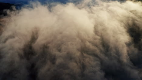 Billowing-clouds-of-smoke-against-a-blue-sky,-dynamic-and-dramatic-scene