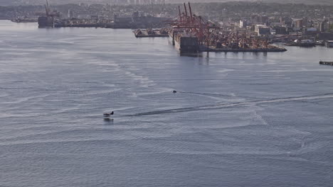 Vancouver-BC-Canada-Aerial-v79-drone-flyover-the-harbour-capturing-seaplane-epic-take-off-on-the-water-into-the-sky-against-industrial-area-and-North-mountain---Shot-with-Mavic-3-Pro-Cine---July-2023