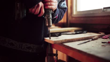 Man-Using-A-Cordless-Driller-To-Make-Hole-On-Plank-Then-Used-A-Hand-Saw