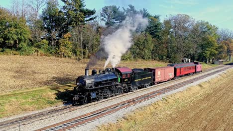 An-Aerial-View,-of-an-Antique-Steam-Freight-Passenger-Train-Blowing-Smoke-as-it-Stopped-on-an-Autumn-Day