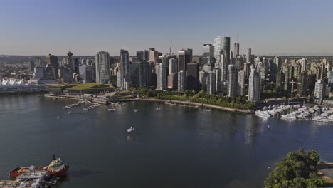 Vancouver-BC-Canada-Aerial-v83-drone-captures-an-amphibious-aircraft-crossing-the-harbour-and-epic-landing-on-the-water-against-waterfront-downtown-cityscape---Shot-with-Mavic-3-Pro-Cine---July-2023