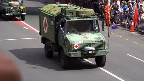 Armoured-Medical-Evacuation-Vehicle-driving-down-the-street-during-annual-Anzac-Day-parade,-Brisbane-city,-Australia,-close-up-shot