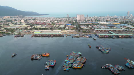 Drone-Pull-Back-Over-Danang-Harbour-With-Fishing-Boats-Below-In-Vietnam