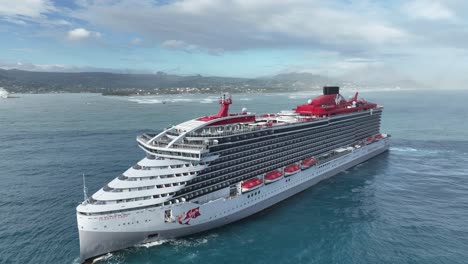 Virgin-cruise-ship-in-open-sea-close-to-Puerto-Plata-coast-in-Dominican-Republic,-aerial-drone-circling-view