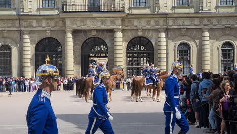 Stockholm,-Sweden,-Royal-Guards-Ceremony-on-Parade-Square-in-Old-Town-With-Marching-Military-Band-on-Horses-on-Sunny-Day