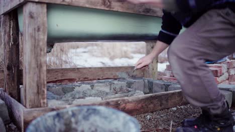 Man-Laying-Concrete-Block-And-Putting-Cement-Using-A-Finishing-Trowel