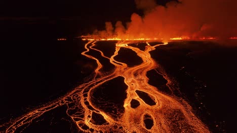 Volcanic-fissure-eruption-in-Iceland-at-night-with-rivers-of-lava-flowing,-aerial