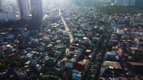 Aerial-tilt-shot-of-houses-and-streets,-in-sunny-Tejeros,-Makati-city,-Philippines