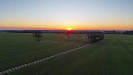 Farmland-fields-and-growing-rows-of-crops-at-sunset---aerial-hyper-lapse
