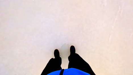 Person-walking-on-ice,-POV-view