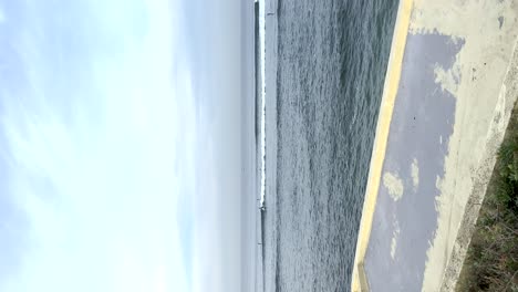 Vertical-view-of-the-calm-sea-at-the-sandy-Cascais-beach-in-Portugal