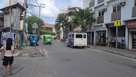 Street-Traffic-on-Boracay-Island,-Philippines,-Motorbikes,-Tuk-Tuk-Vehicles-and-People