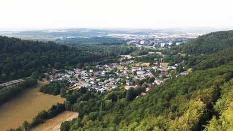 Aerial:-Embark-on-an-aerial-journey-through-the-verdant-forests-and-charming-small-cities-of-Saarland,-Germany,-as-drone-footage-unveils-the-serene-beauty-of-the-region-from-above