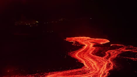 Fiery-red-lava-flow-at-night-in-Iceland-during-new-2024-eruption,-aerial