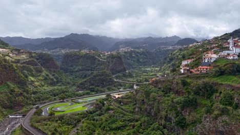Santana,-Madeira-drone-hyperlapse-capturing-urban-life,-moving-clouds,-and-car-on-streets