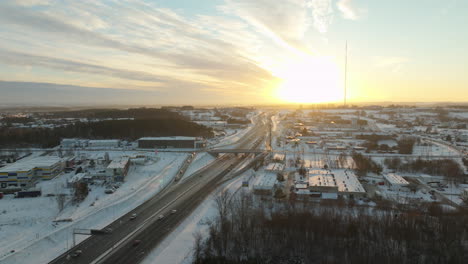 Aerial-establishing-shot-of-highway-with-traffic-in-winter-snow