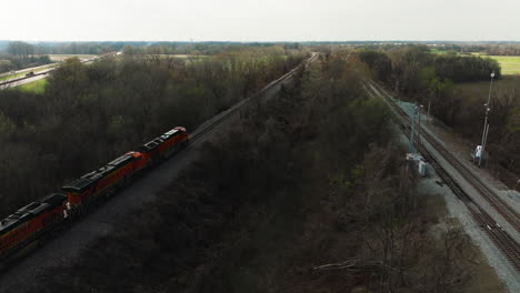 Freight-train-winding-through-West-Memphis-Delta-Regional-River-Park,-TN,-USA,-aerial-view